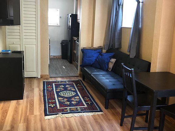 Furnished living room, HD TV, small table and chairs
