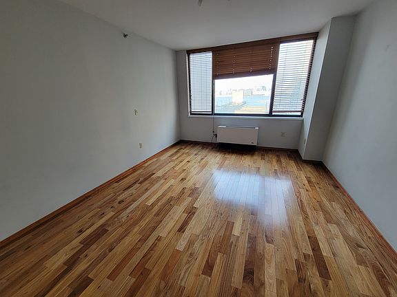 Living room. Has a door, so it can be used as a 2nd bedroom. Faces East. View of Manhattan skyline.
