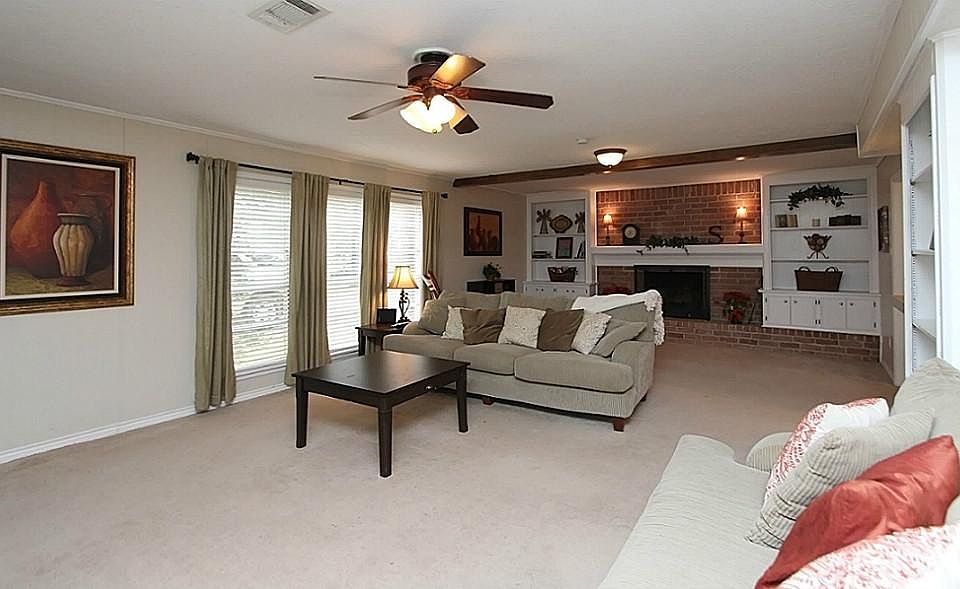 Neutral Paint, Large Windows, and Built in Bookcases are a few of the amenities in this fabulous liv