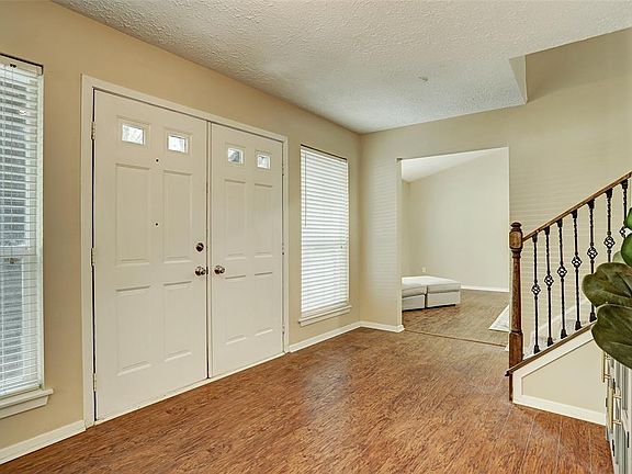 Entry Foyer accessing the Living Room and Den/Game Room at opposite end