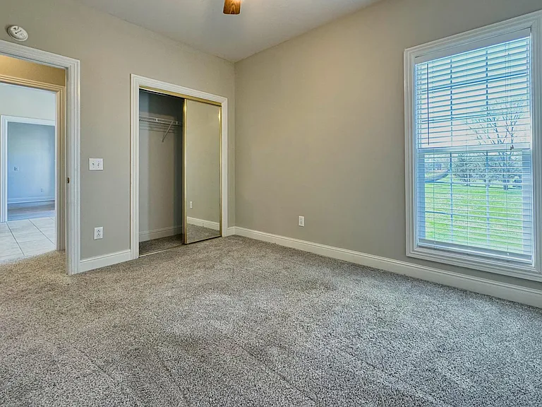 2nd Bedroom - Ceiling Fan Has a small hallway attached to the kitchen, second full bathroom and 3rd bedroom. Window - Views of Backyard 
Has a Large Closet