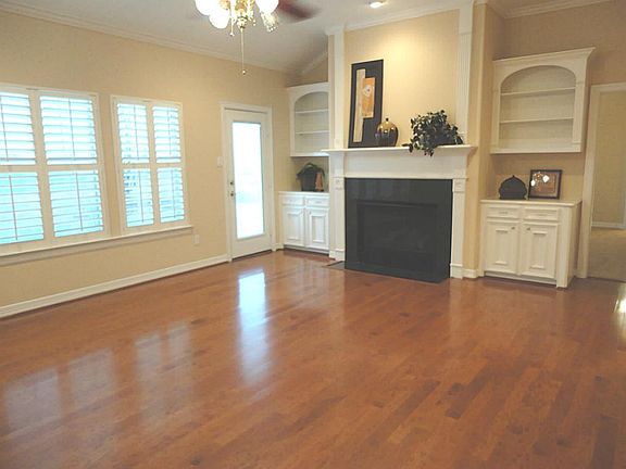 A living area that will be the center for your entertaining...showcases granite surround fireplace and built-ins.