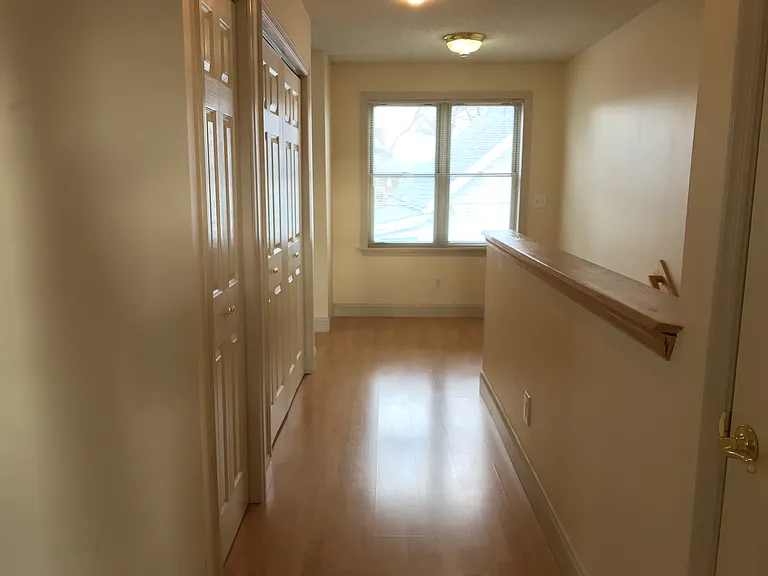 Hallway from Bathroom. Linen Closet and Laundry Closet on the left. Stairs on the Right.