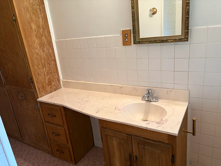 Hall bathroom with large storage cabinet