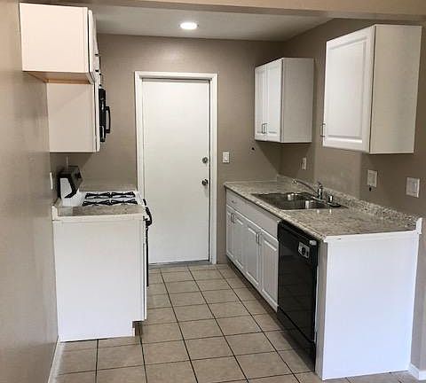 New cabinets, counters, microwave, D/W. Room for a large side by side
