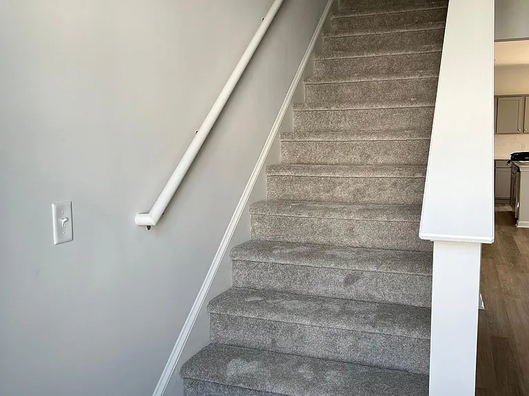 Carpeted stairs main floor up to top floor