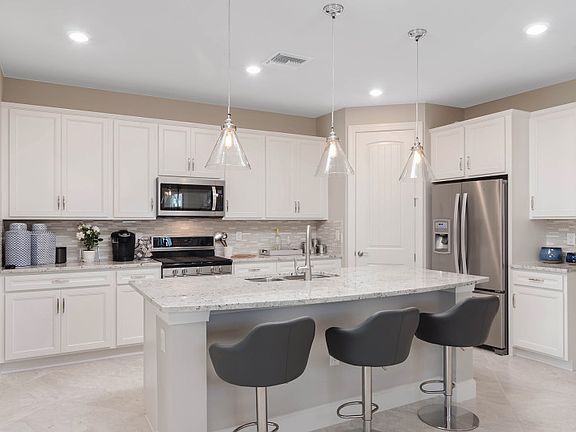 Open kitchen with center island and stainless steel appliance