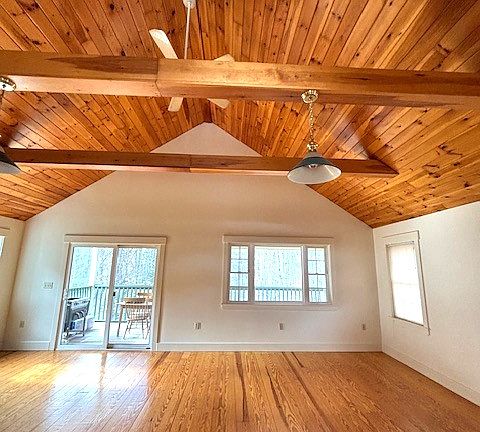 Upstairs view from dining area toward living area and screened porch