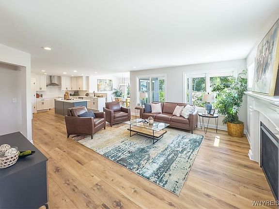 Living room open to sunroom and the kitchen