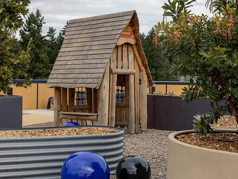East Building Roof Deck amenity featuring a wooden playhouse for children