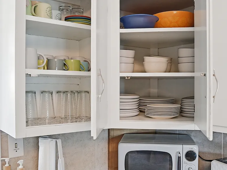 Kitchen fully loaded plates and dishes and glassware