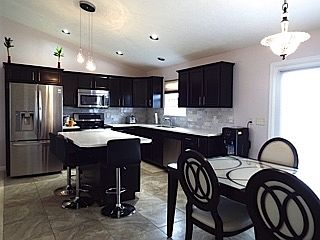Nice kitchen island with solid surface countertops for additional seating and for added workspace.
