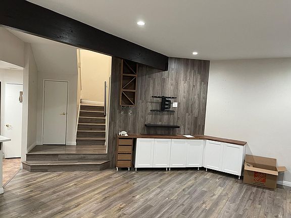 Living area with lots of cabinet space with a place to put wine!