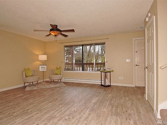 Light and bright living room with fresh paint, new floors, coat closet door.