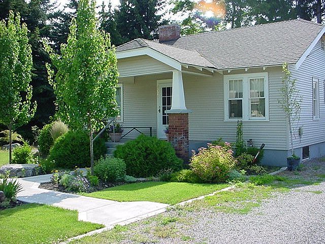 Front of House with summer yard professionally landscaped