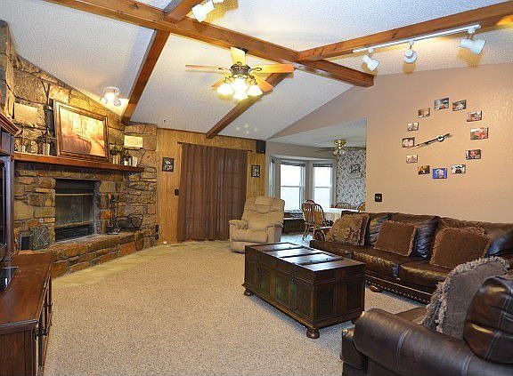 Carpeted floors and wooden beams 