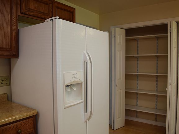 Kitchen has lots of cabinets and a nice pantry.