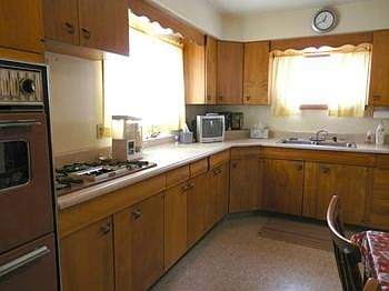 Large kitchen offers lots of cabinets, gas range & refrigerator