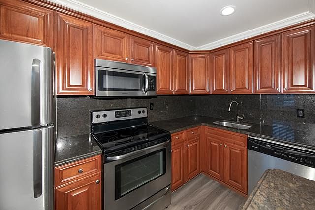 Granite Counters, Tuscany Cabinets, Vinyl Plank Floor