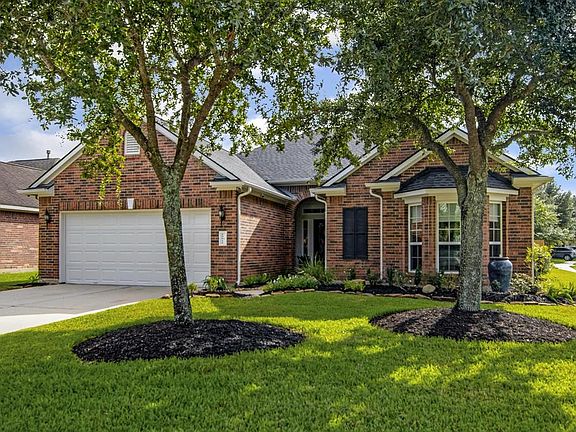 Side yard is lush with mature oleanders in a raised bed.