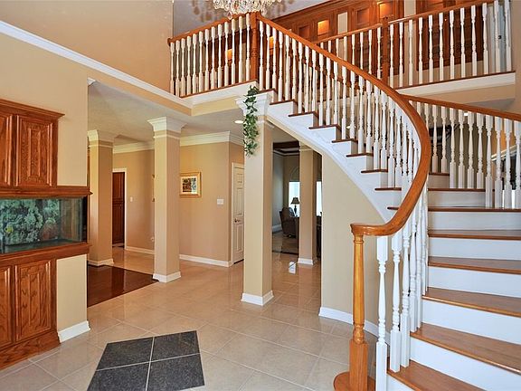 Very open concept with beautiful crown molding and built in display cabinets.