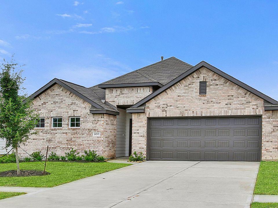Impeccable brick facade with a stylish gabled roof and expansive garage in a desirable suburban loca