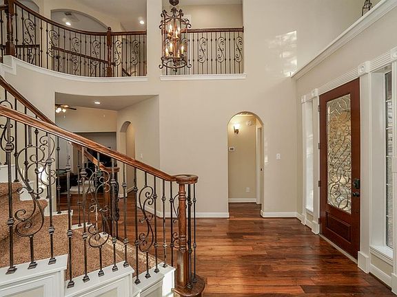 You'll enter in to the two story foyer through the recently varnished front door with leaded glass details. The guest suite is tucked away to the right of the entry.