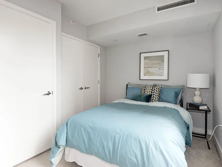 2nd bedroom with large closet and queen sized bed