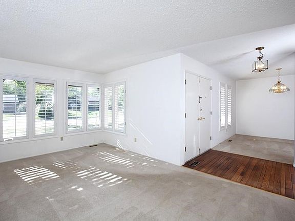Living room features plantation shutters