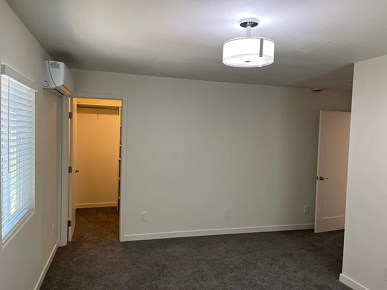 Bedroom #1 looking towards walk-in closet.
Mini-split for heating and air conditioning.