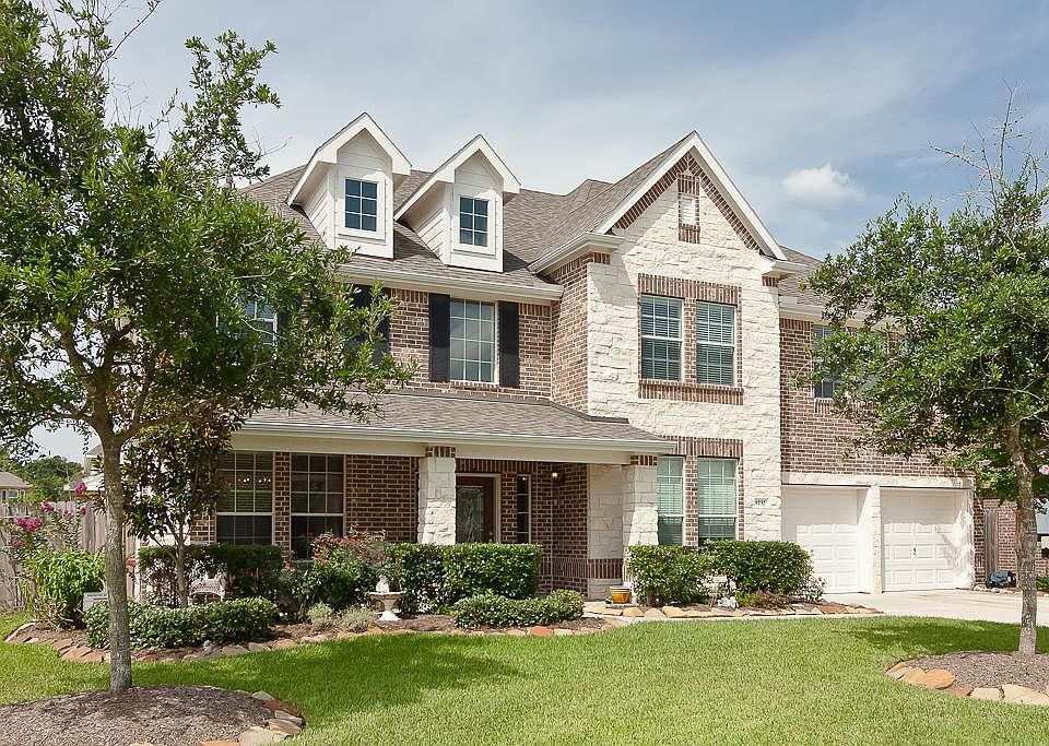 Welcome to 1232 Chuck Drive! This 2-story 3833 square foot home with white stone and brick front ele