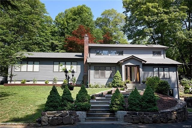 Beautiful stone masonry and flagstone steps lead to this wonderful country Contemporary.
