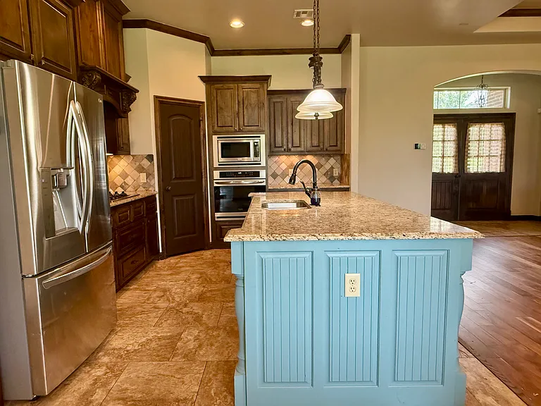 Power Outlet on the end of the kitchen island allows for the convenience with entertaining or your favorite appliance. Refrigerator is negotiable. Stove is gas which is the perfect kitchen for a chef!