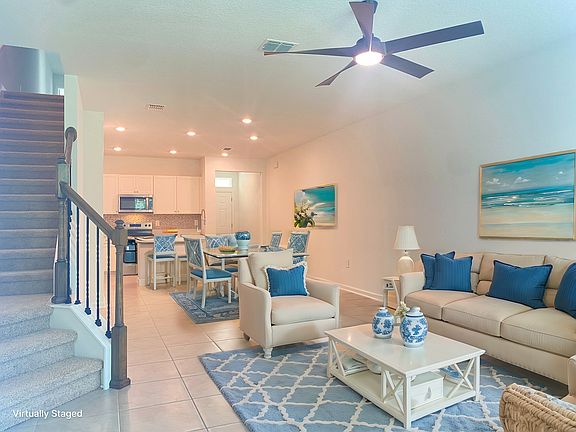 Living, Dining and Kitchen with ceiling fan.
Virtually staged