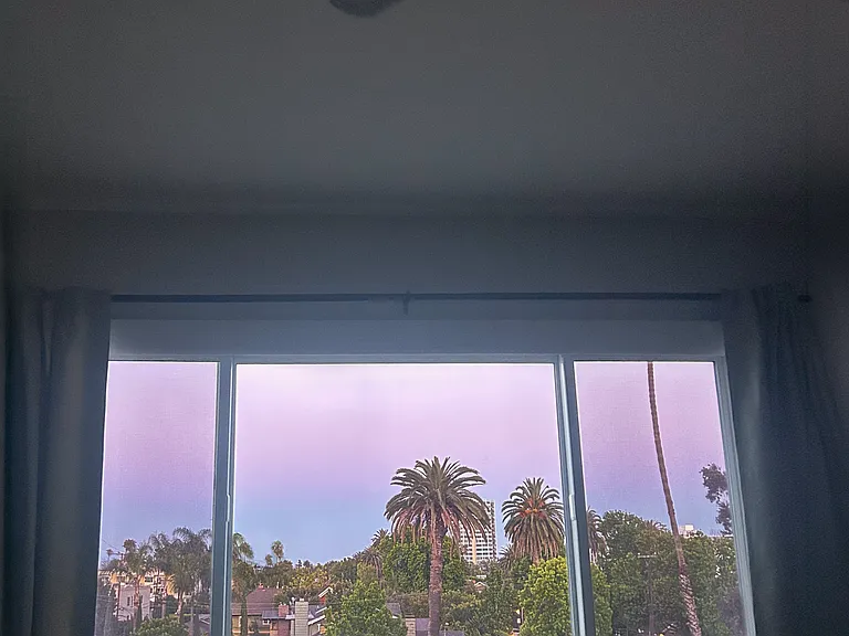 Sunset from the primary bedroom. Palm tree and ocean views throughout