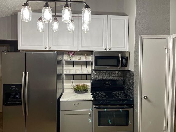 New cabinets, light fixture, backsplash and paint.