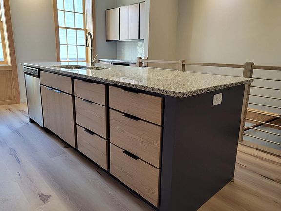 Custom kitchen cabinetry, granite countertops, vinyl plank flooring.