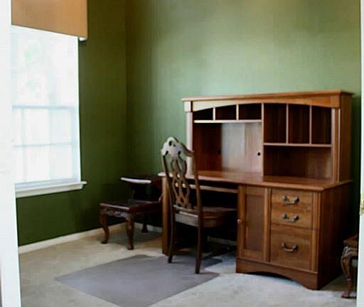 Study with vaulted ceilings and great view of front lawn.