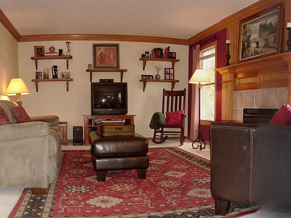 Large family room dominated by the warmth of a beautiful gas fireplace