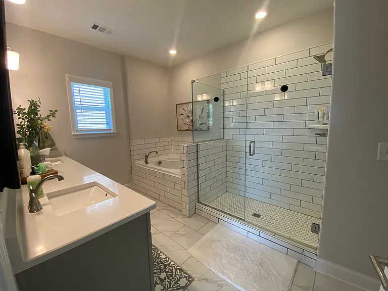 Primary bathroom with soaking tub and walk-in shower.