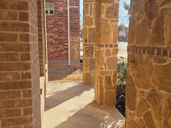Front porch - trees/shrubs and plants trimmed and mulch replaced
