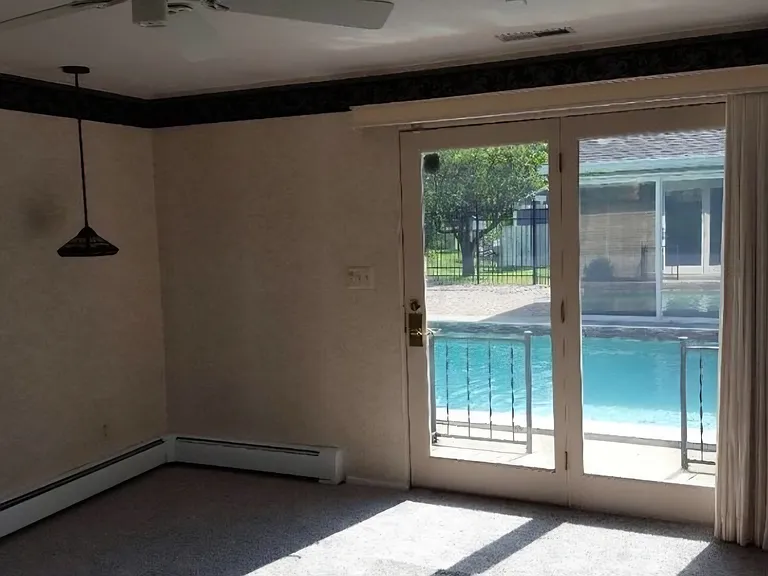 Master bedroom with door to pool area.