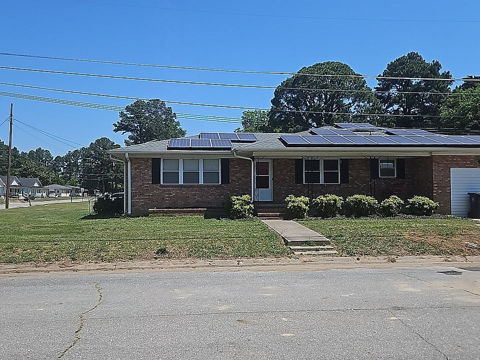 Large family home featuring solar panels. Spacious layout ideal for comfortable family living with modern, eco-friendly benefits.