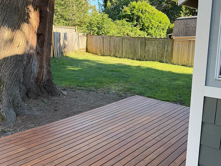 Deck and fenced in backyard
