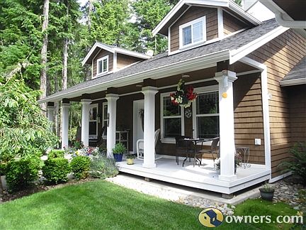 Sit on the covered front porch and enjoy the outdoors.