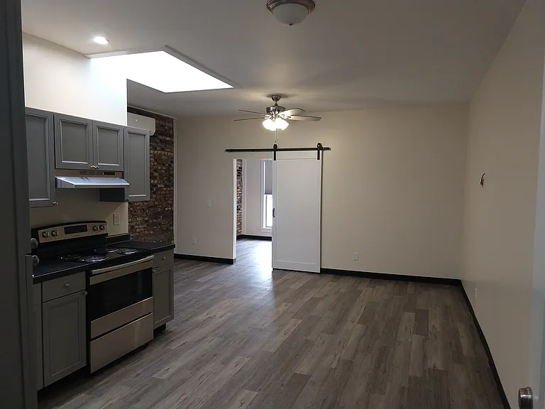 View upon entering the unit. The bedroom door is directly ahead.