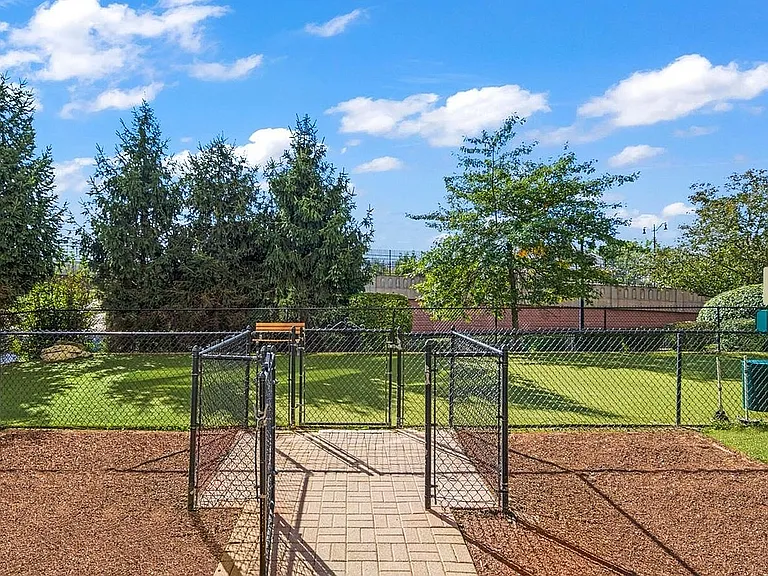 Enjoy serene outdoor moments in this beautifully maintained backyard, perfect for relaxation and play.