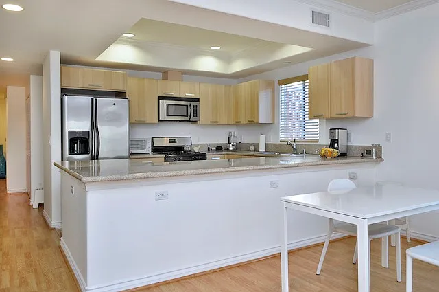 Dining area and kitchen with prior tenant's furniture