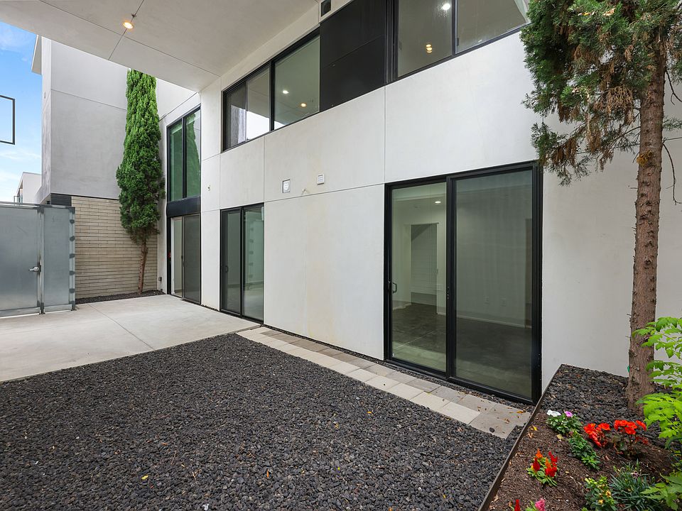 Private Courtyard - Fully Enclosed and Fenced, featuring a garden with planted vegetables and herbs.