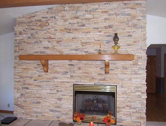 The floor to ceiling stone fireplace is the focal point.